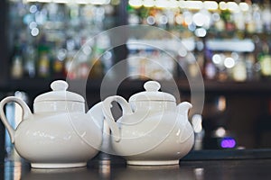 Bar counter with two white teapots