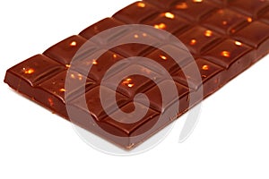 A bar of dark chocolate with hazelnuts