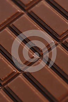 Bar of delicious milk chocolate closeup.