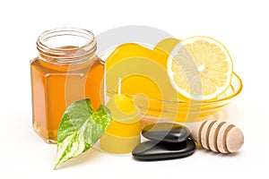 Bar of glycerin soap, jar of honey and lemon photo