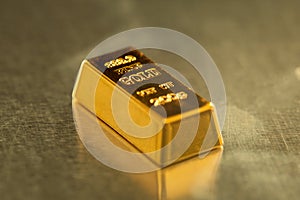 Bar of gold on metal background