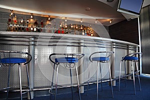 Bar interior with round counter and stools