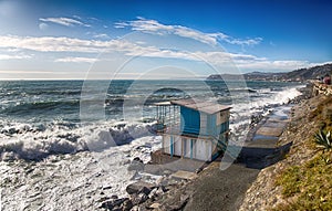 The bar on a mediterranen beach with rough sea in a sunny day, Italy.