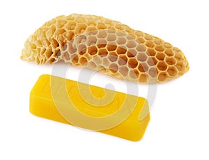 A bar of natural beeswax and a piece of bee honey on a white background. Beekeeping products. Apitherapy