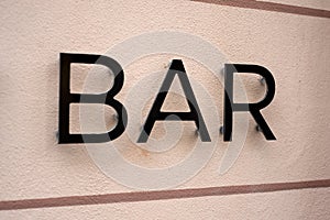 bar signage on the wall in the street