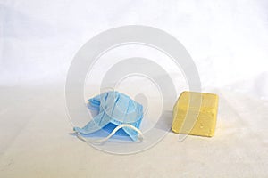 Bar of soap and a medical mask on a white background