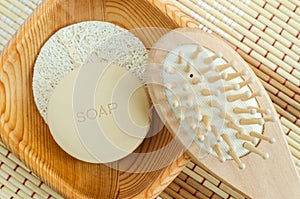Bar of soap solid shampoo and wooden massage hair brush. Eco friendly toiletries. Natural beauty treatment and skin care