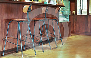 Bar stool with backrest made of wood, legs made of steel.