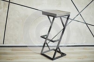 Bar stool made of wood and metal.