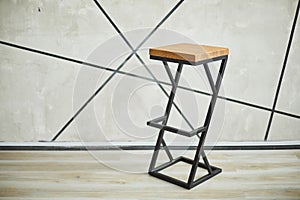 Bar stool made of wood and metal.