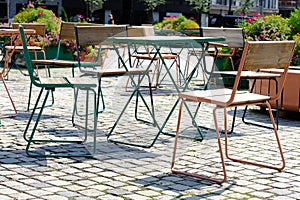 Bar tables and chairs on a city street photo