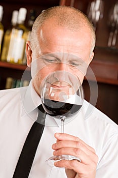 Bar waiter smell glass red wine restaurant