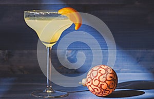 Bar winter season cocktail menu. Winter cocktail drink concept. Alcohol cocktail margarita with piece of orange near