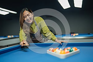 bar worker smiling while standing on the pool at the biliard studio