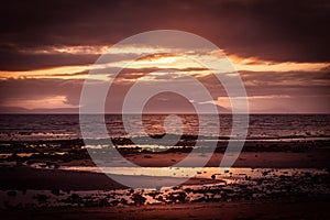 Barassie Shore Troon in Ayrshire Scotland with red moody sky