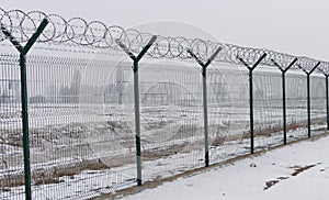 Barb wire fence at the cold winter day