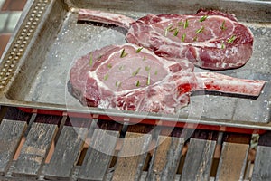 Barbacue concept, Two raw pork steaks with rosemary