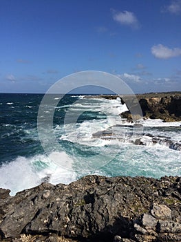 Barbados coast with crashing waves, blue sky and deep blue sea