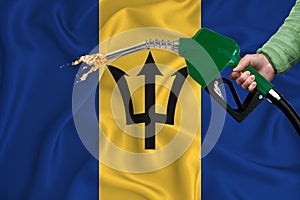 BARBADOS flag Close-up shot on waving background texture with Fuel pump nozzle in hand. The concept of design solutions. 3d