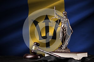 Barbados flag with statue of lady justice, constitution and judge hammer on black drapery. Concept of judgement and