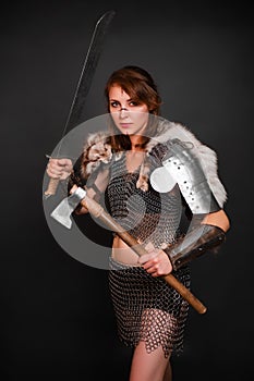 Barbarian woman warrior in chainmail armor with bracers, armor shoulder pad, polar fox fur on her shoulders