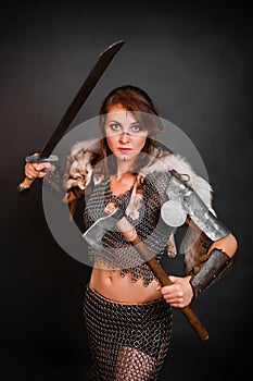 Barbarian woman warrior in chainmail armor with bracers, armor shoulder pad, polar fox fur on her shoulders
