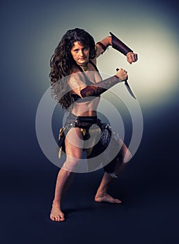 Barbarian woman warrior. Ritual dance with a knife. photo