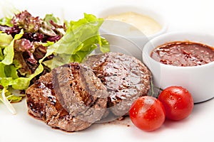 Barbecue Beef Steaks medium grilled with white and red sauces