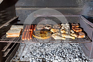 Barbecue or braai over traditional wood coals in South Africa