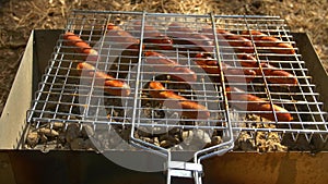 Barbecue browned sausages on the hot grill, turn