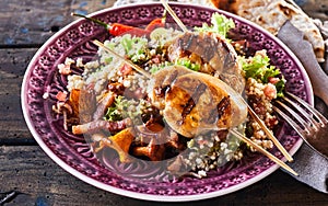 Barbecue chicken skewer dish with quinoa close up