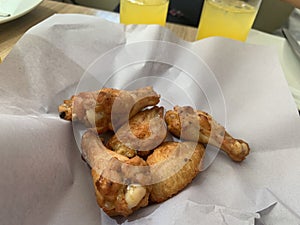 barbecue chicken wings or buffalo wings close up on wooden tray shot with selective focus