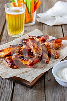 Barbecue chicken wings with carrots, celery and white sauce. Grill. Recipe