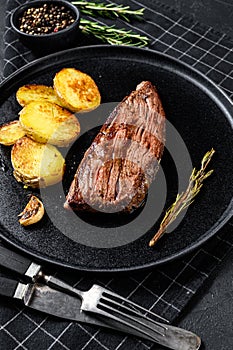Barbecue dry aged wagyu flank steak. Black background. Top view