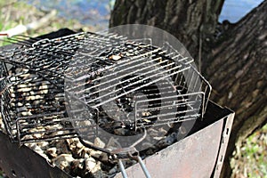 Barbecue grates and a grill with coals