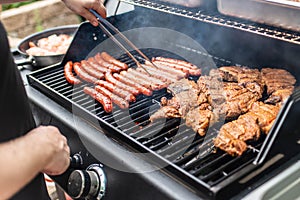 Barbecue grill bbq on propane gas grill steaks bratwurst sausages meat meal