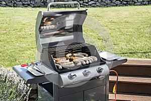 Barbecue grill bbq on propane gas grill steaks bratwurst sausages meat meal