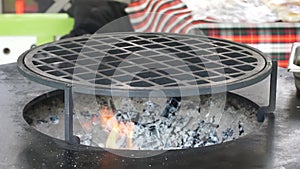 Barbecue grill and glowing embers.Empty hot charcoal grill with a bright flame.Burning coals, bonfire, beautiful flame