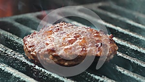 Barbecue grill. Juicy meat patty is cooked on coals for party in nature