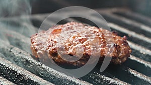 Barbecue grill. Juicy meat patty is cooked on coals for party in nature