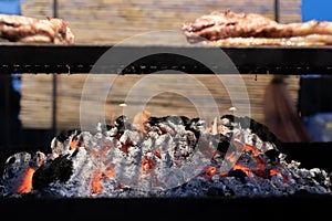 Barbecue grill with meat steaks and burning coals