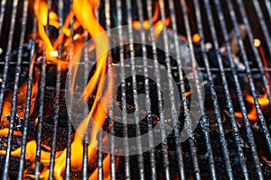 Barbecue grill pit with glowing and flaming hot open fire with red flame