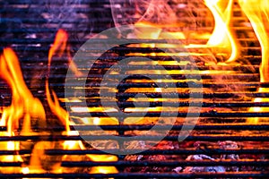 Barbecue grill pit with glowing and flaming hot open fire with red flame