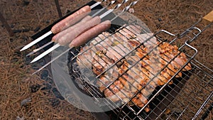 Barbecue in the grill and sausages are fried on the grill, close-up. Outdoor barbecue