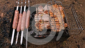 Barbecue in the grill and sausages are fried on the grill, close-up. Outdoor barbecue