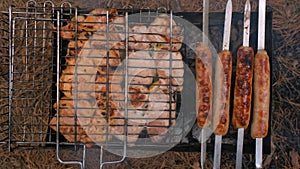 Barbecue in the grill and sausages are fried on the grill, close-up. Outdoor barbecue