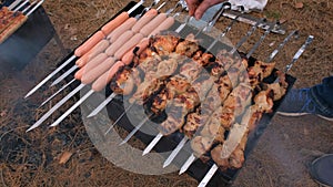 Barbecue in the grill and sausages are fried on the grill, close-up. Outdoor barbecue