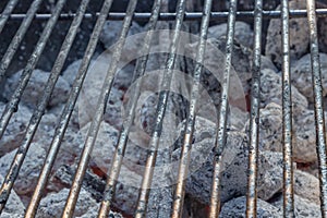 Barbecue grillage with hot coal briquets under it. photo