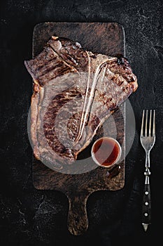 Barbecue Grilled Dry Aged Beef T-bone Steak on Rustic Cutting Board
