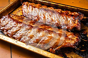 Barbecue grilled pork spare ribs. Orange background. Top view